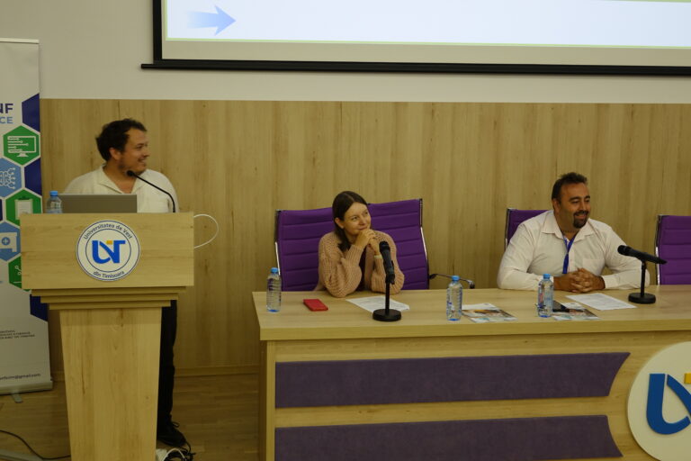 People in the front smiling at the presentation